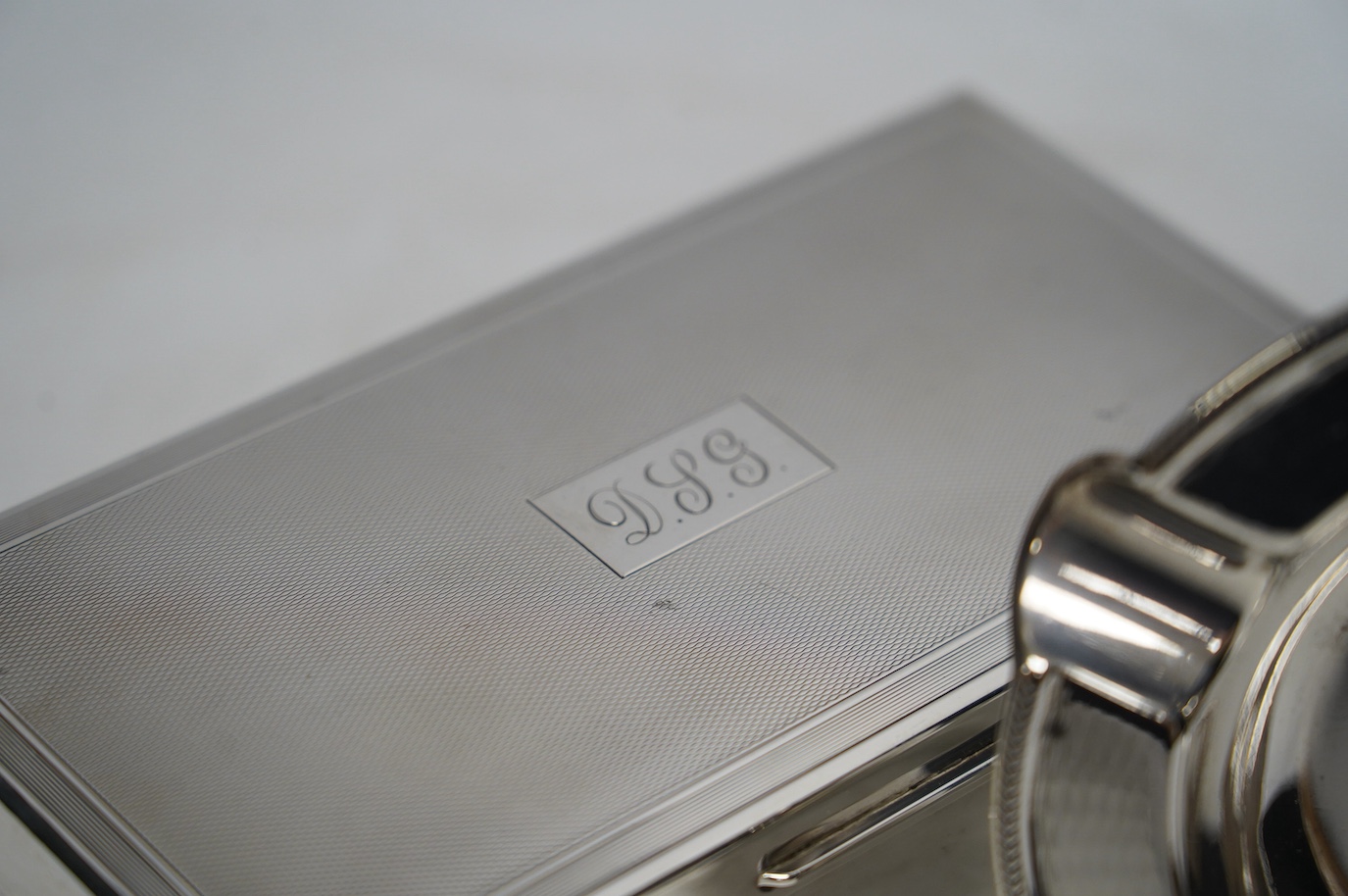 A 1960's engine-turned silver mounted rectangular cigarette box, 17.8cm and a silver ashtray. Condition - fair